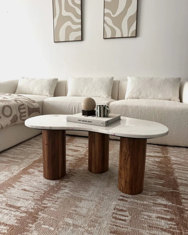 Modern living room with a white sofa and wooden coffee table.