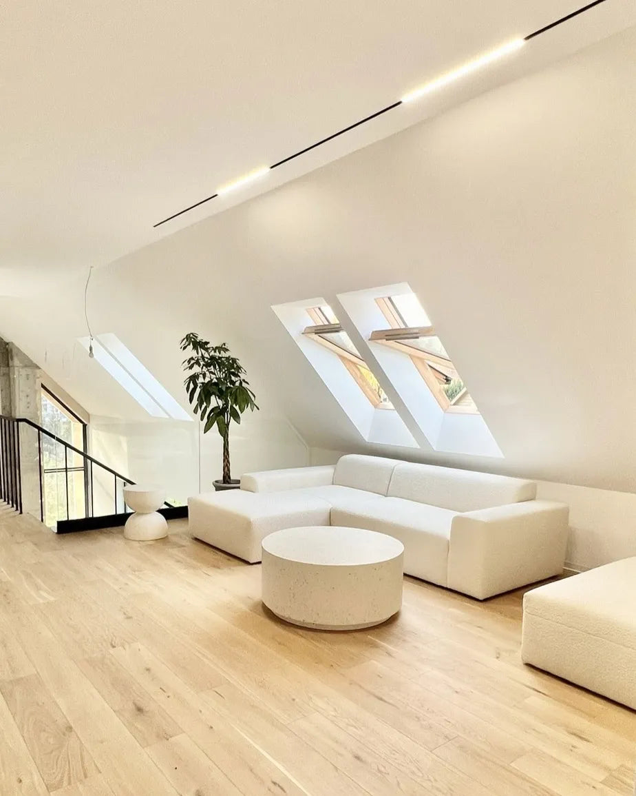 Modern living room with white furniture and skylights