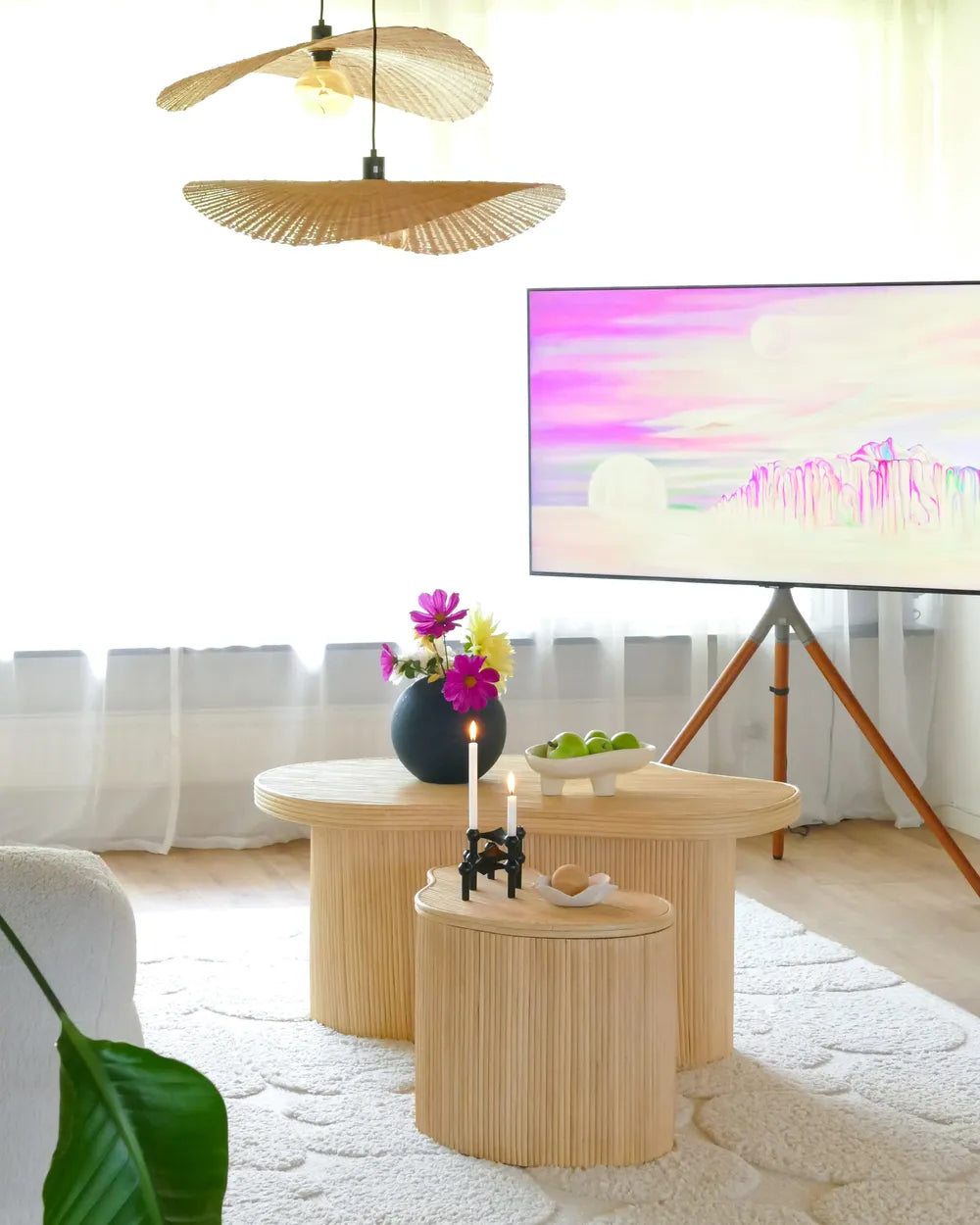 Modern living room with wooden side tables, decorative items, and a TV.