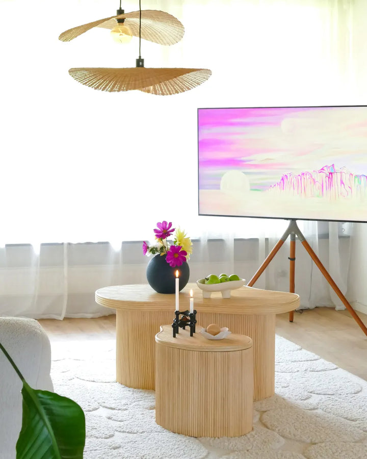 Modern living room with wooden side tables, decorative items, and a TV.