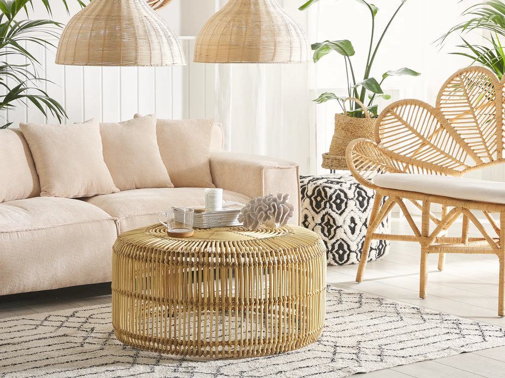 Living room with beige sectional sofa, wicker coffee table, and rattan chair.