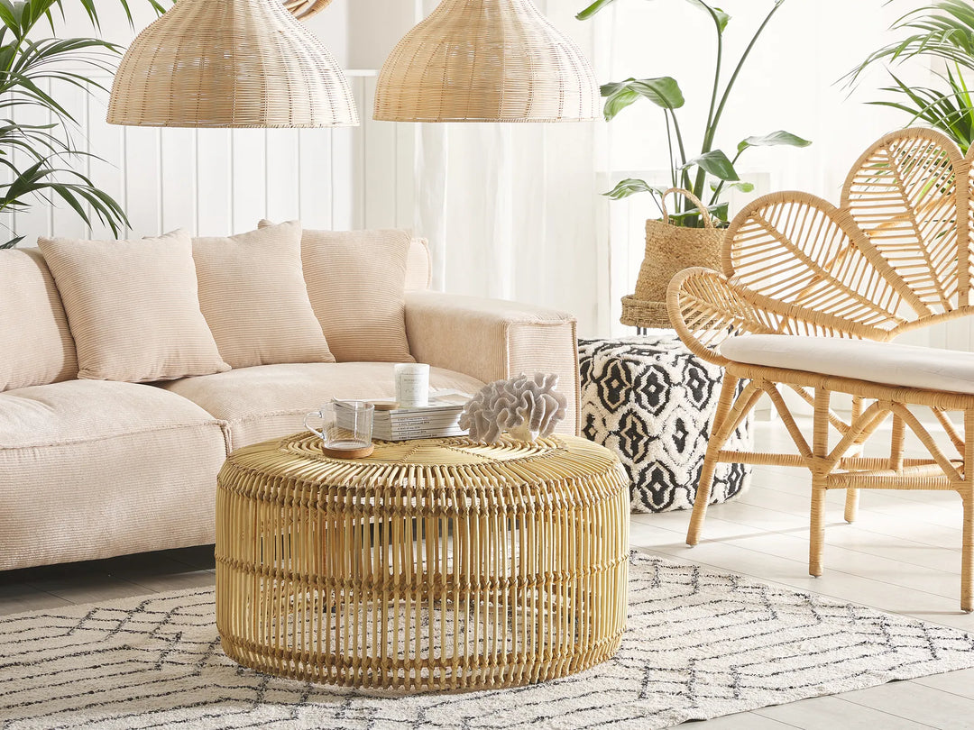 Living room with beige sectional sofa, wicker coffee table, and rattan chair.