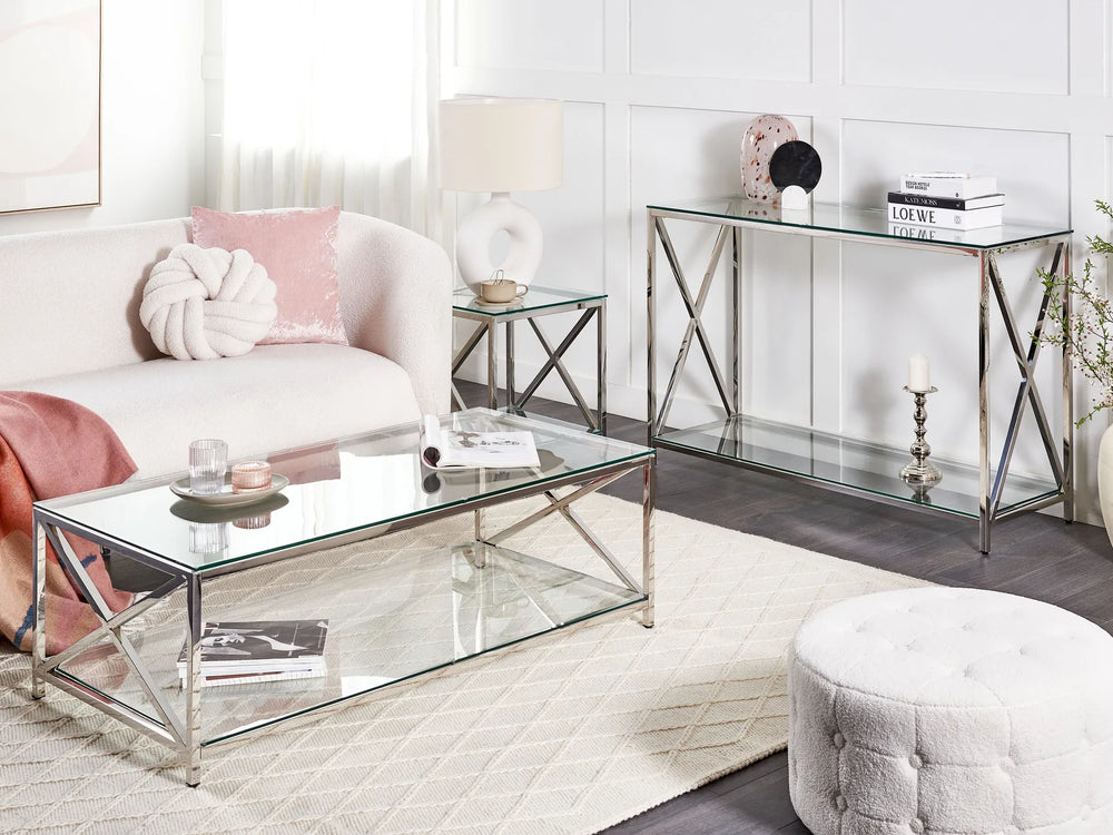 Modern living room with white sofa, glass coffee table, and decorative items.