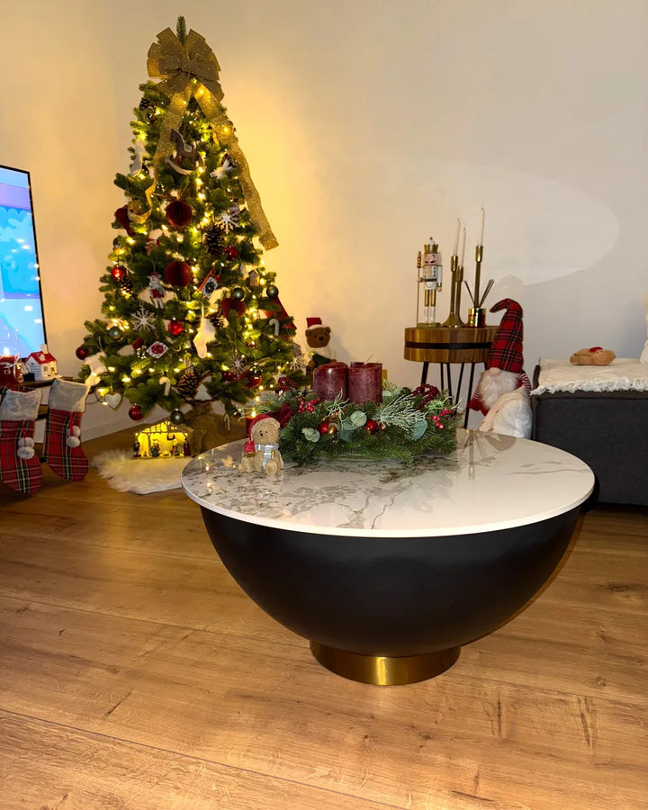 Living room with a decorated Christmas tree, wreath, and festive decor.