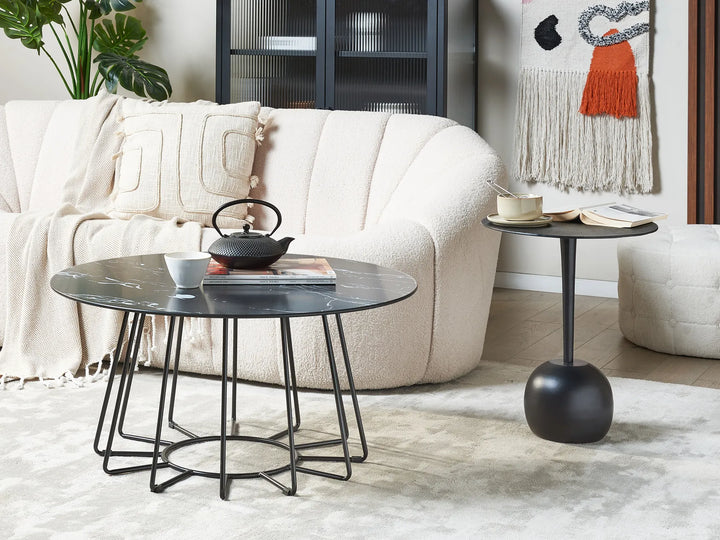 Living room with a white sofa, black coffee table, and side table.