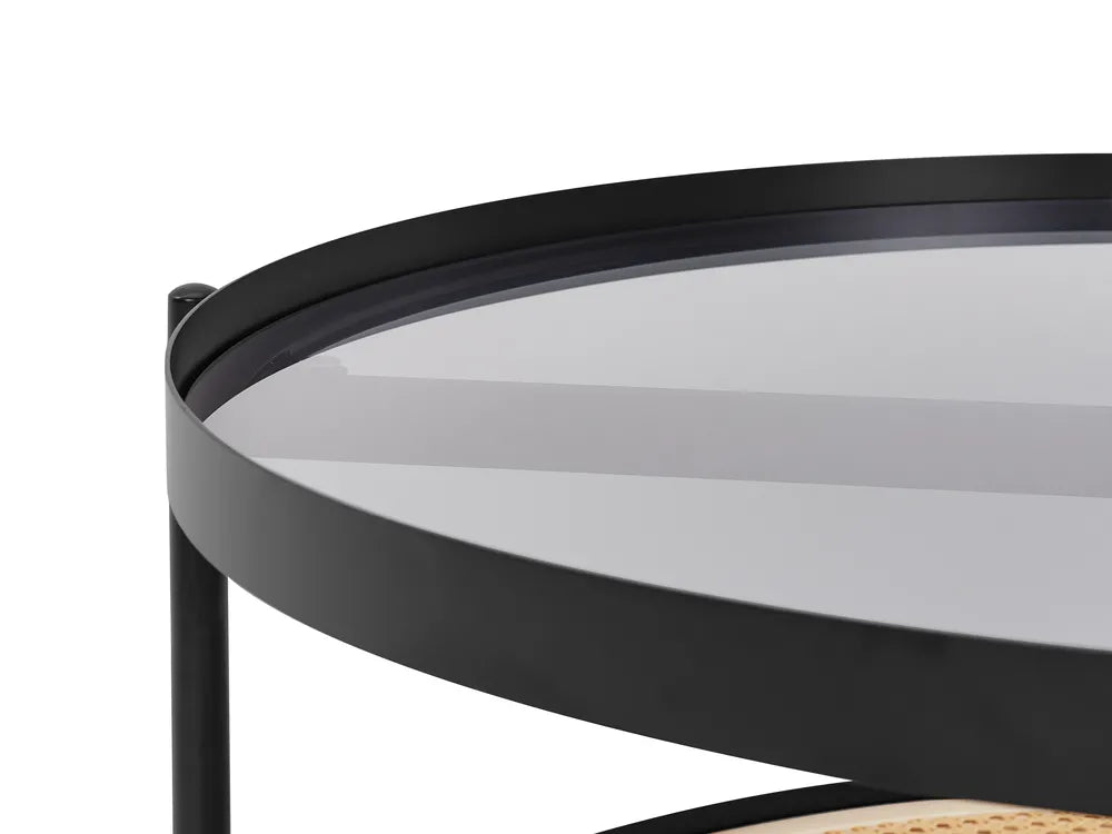Round black metal table with glass top on a white background
