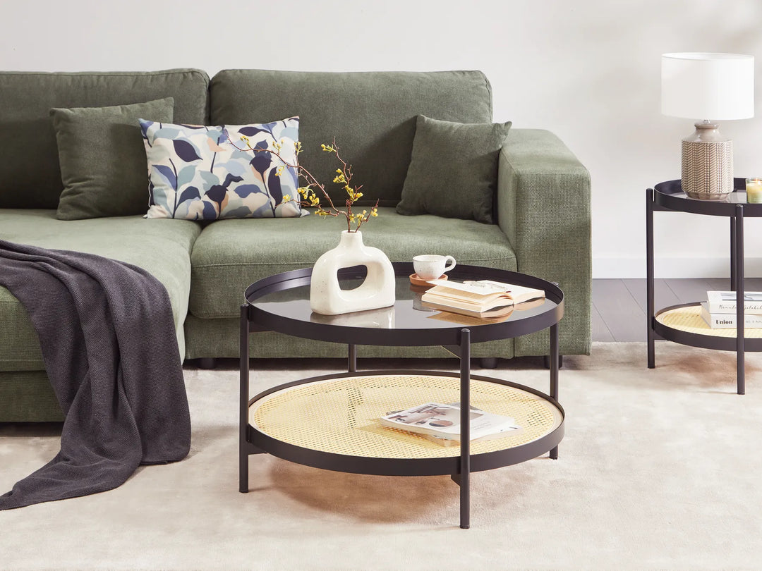 Green sofa with decorative pillows and a coffee table in a living room setting.