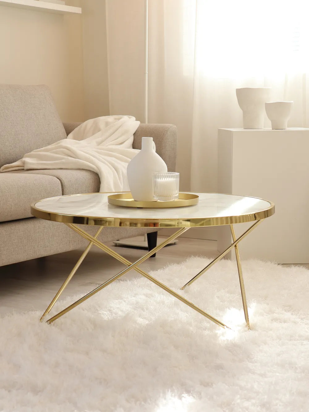 Modern coffee table with gold legs in a living room setting
