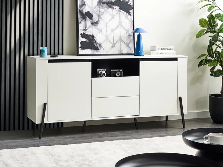 Modern white sideboard with black accents in a living room setting.