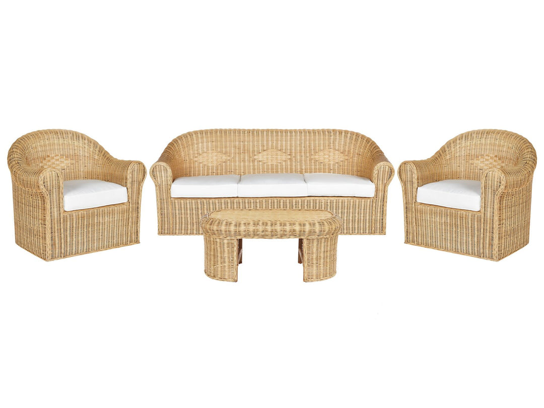 A Boho-inspired garden sofa set made of natural rattan, including a 3-seater sofa, two armchairs, and a coffee table, all equipped with white cushion covers.