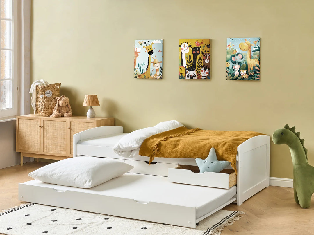 Children's bedroom with a white bed, wooden sideboard, and wall art.