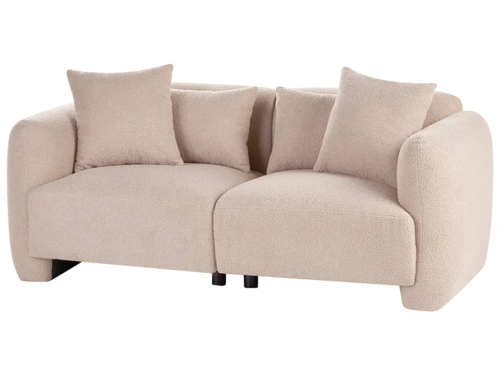 A modern two-seater sofa upholstered in a textured bouclé fabric in a light beige color, featuring four matching throw pillows and small black legs, shown against a plain white background.