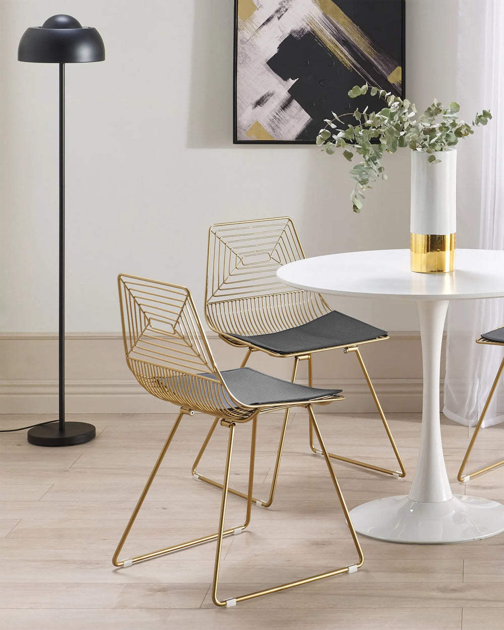 Gold metal chairs with curved backrests