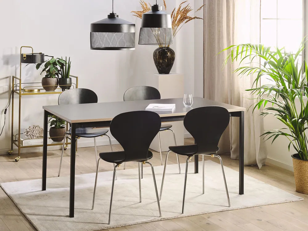 Dining room with a table and chairs, plants, and decorative items.