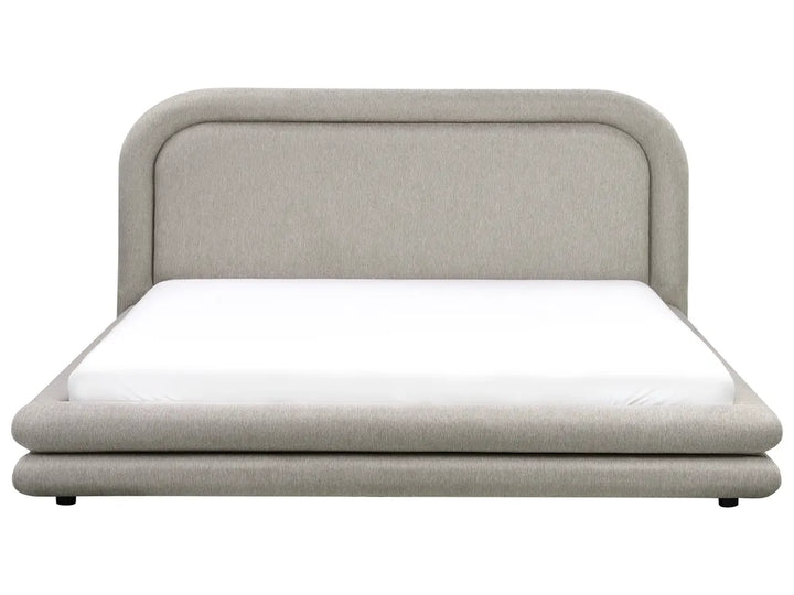 Beige upholstered bed with white mattress on a white background