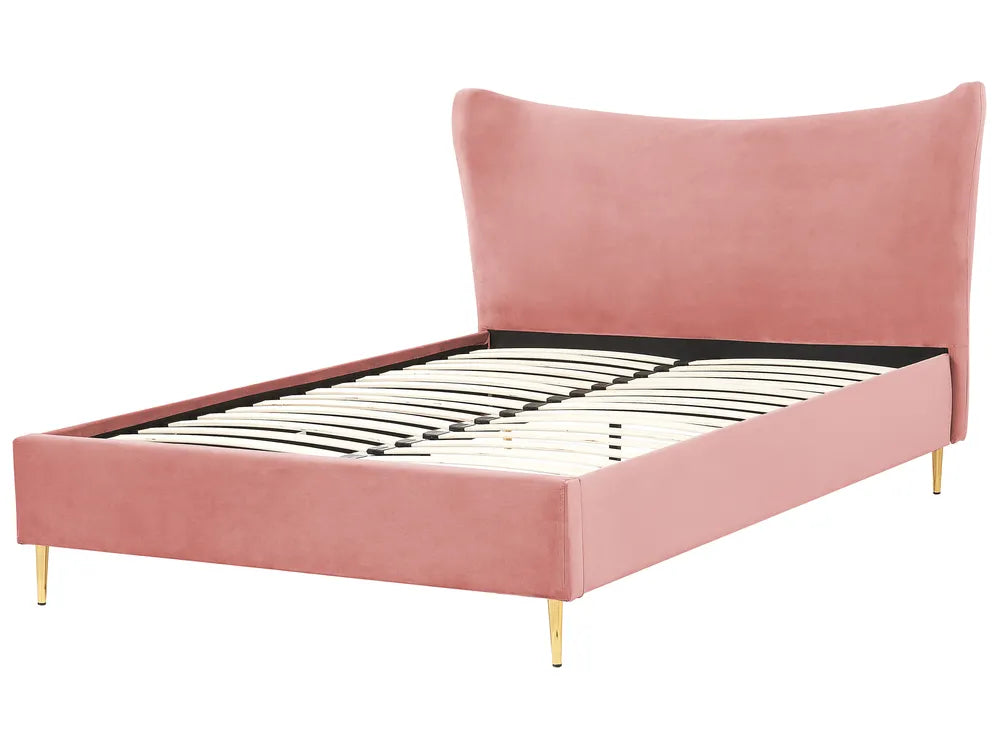 Pink upholstered bed with metal frame on a white background