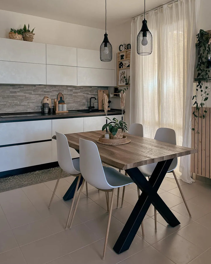 Modern kitchen with a wooden dining table and chairs.