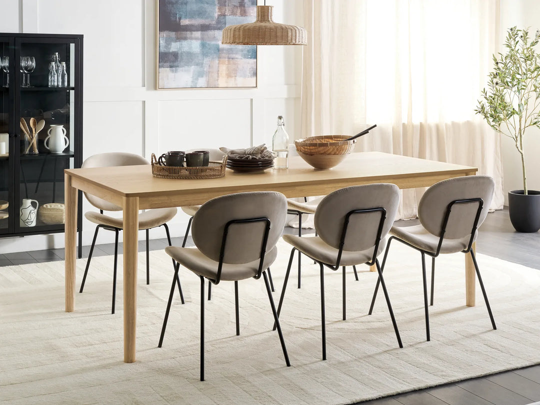 Dining room with a wooden table and chairs in a modern interior setting.