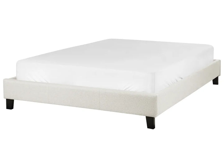 White bed frame with mattress on a white background
