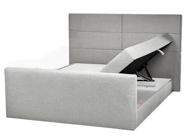 Gray upholstered bed with storage compartments on a white background