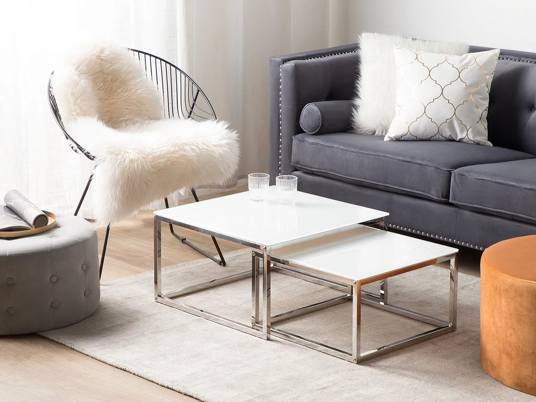 Modern living room with gray sofa, white coffee table, and decorative chair.
