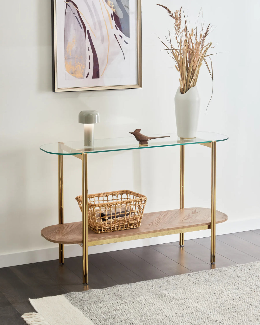 Glass console table with wooden shelf against a white wall