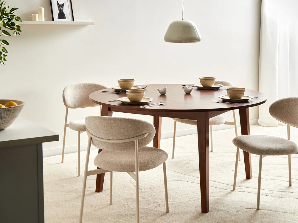 Dining room with a wooden table and chairs in a bright room.