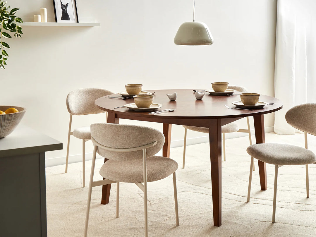 Dining room with a wooden table and chairs in a bright room.