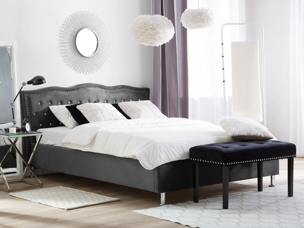 Upholstered velvet bed with button detailing and nailhead trim