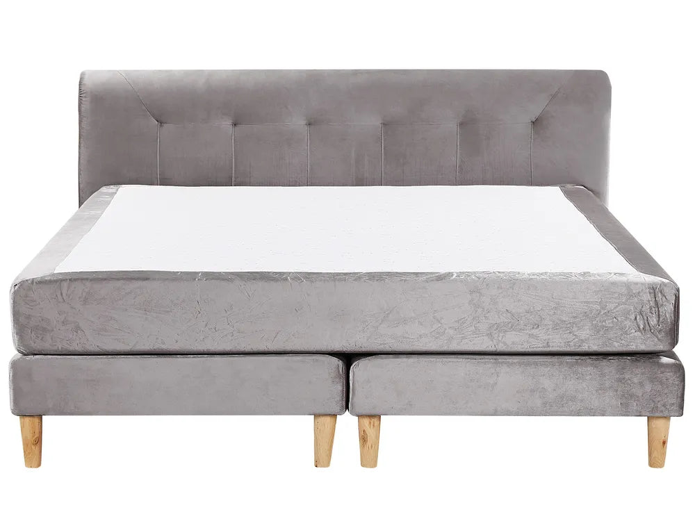 Gray upholstered bed with tufted headboard on a white background