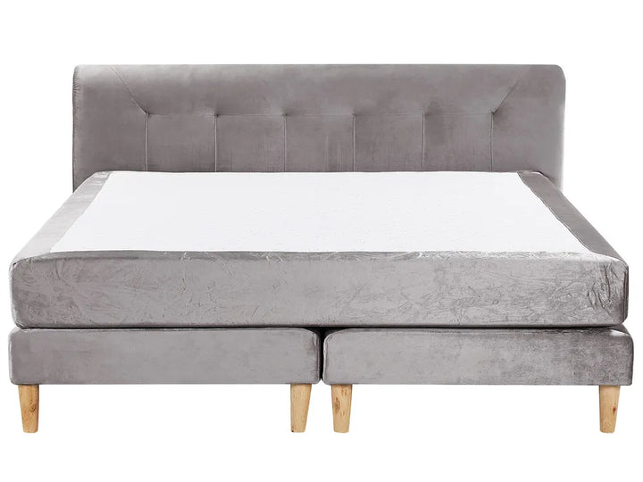 Gray upholstered bed with tufted headboard on a white background