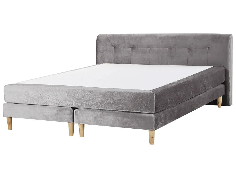 Gray upholstered bed with wooden legs on a white background