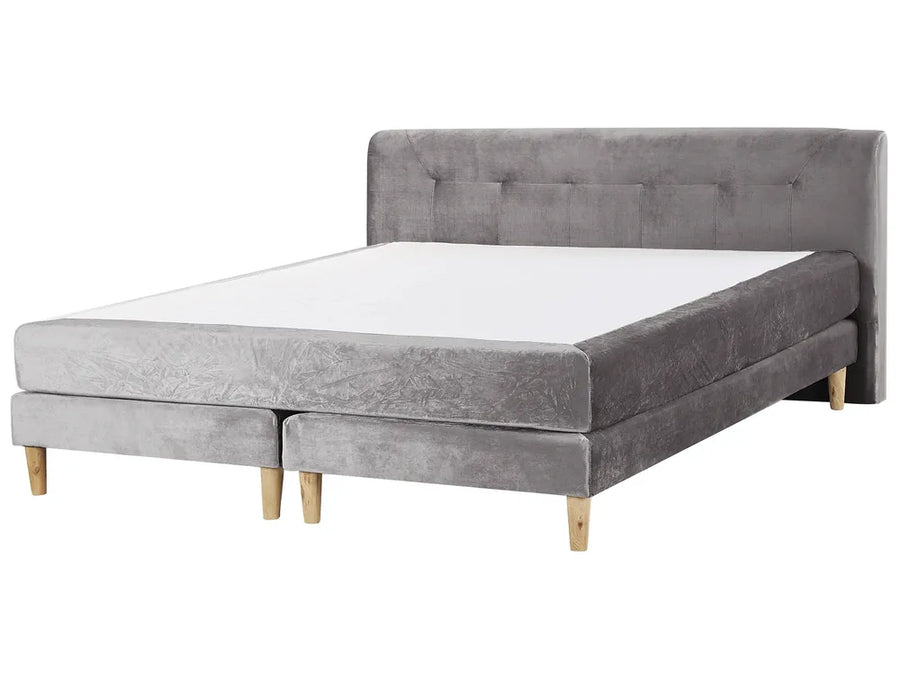 Gray upholstered bed with wooden legs on a white background