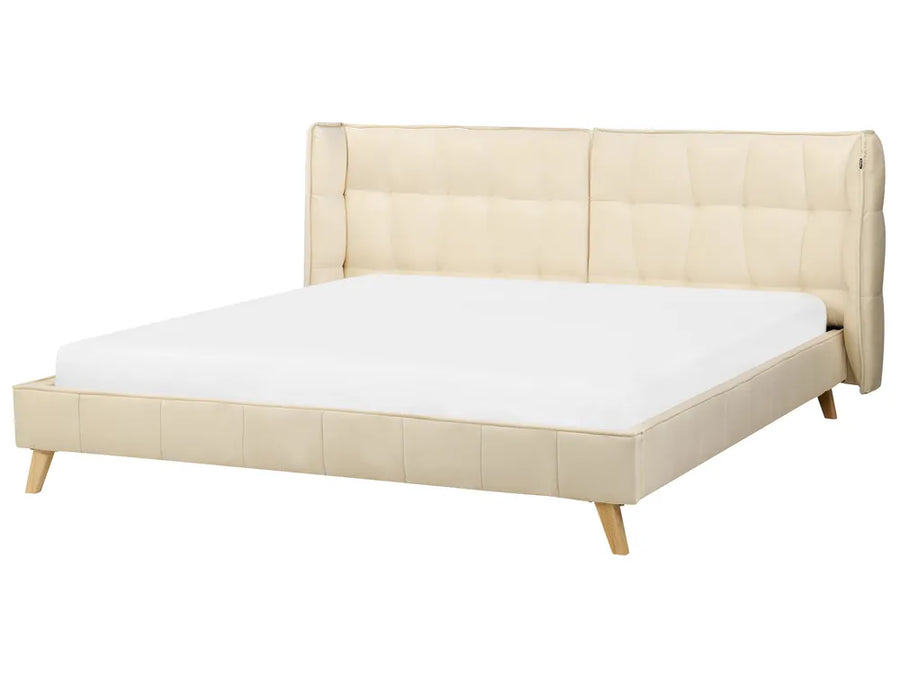 Beige upholstered bed with white mattress on a white background