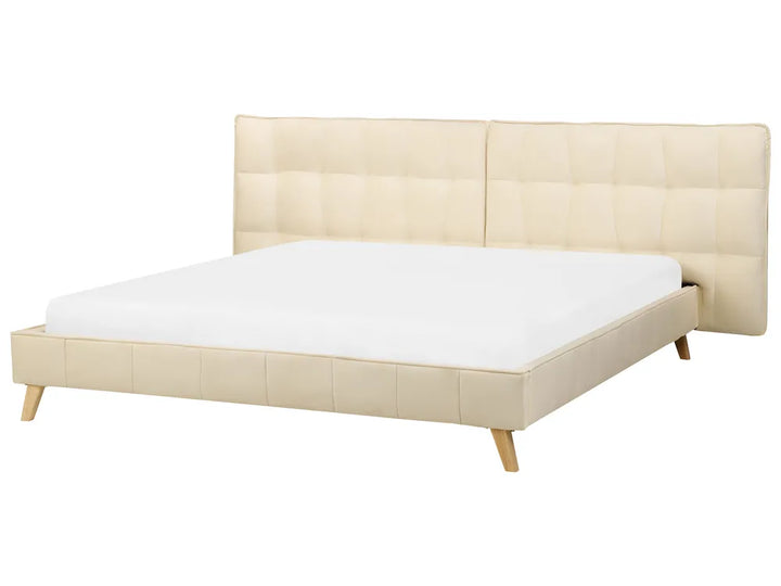 Beige bed frame with white mattress on a white background
