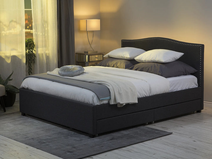Upholstered bed with camelback headboard and nailhead trim
