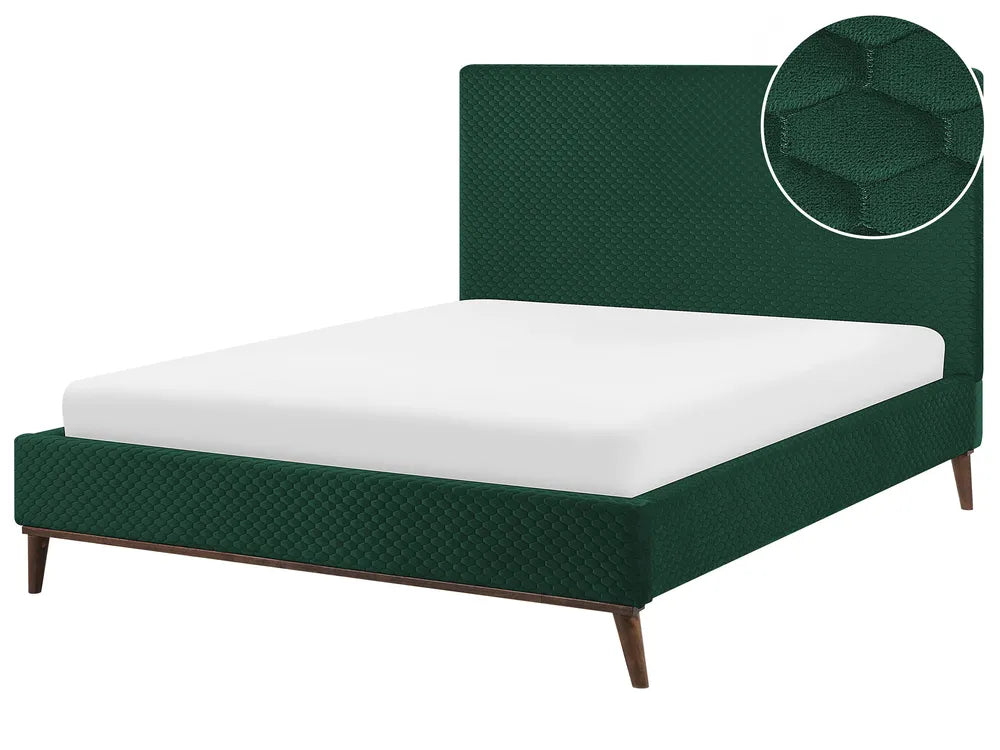Green upholstered bed with white mattress on a white background