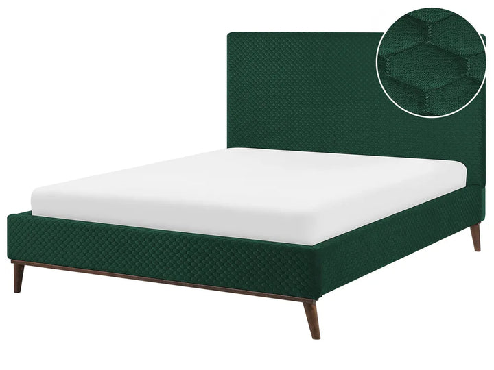 Green upholstered bed with white mattress on a white background