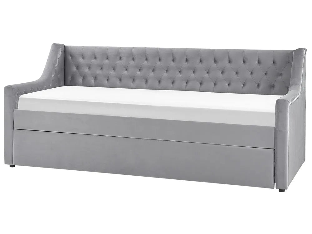 Gray upholstered bed with tufted design on a white background