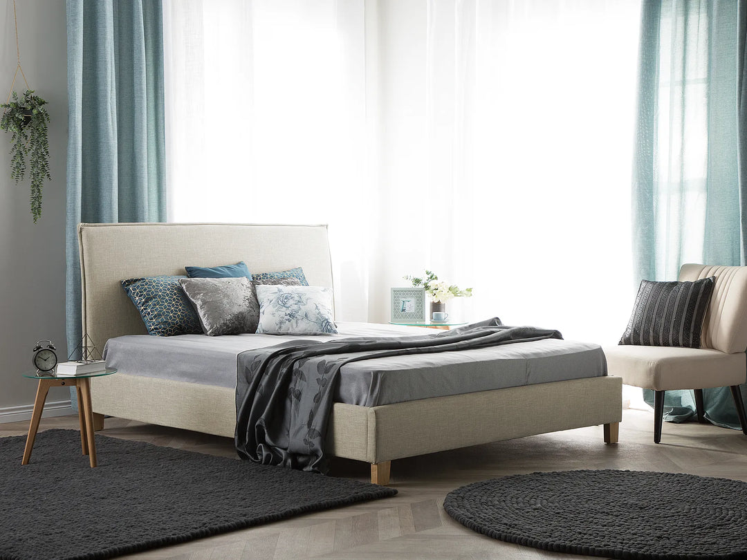 Neatly made bed with decorative pillows in a bedroom setting.