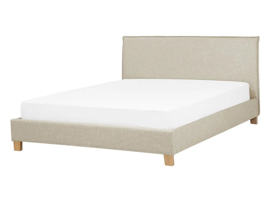 Beige upholstered bed with white mattress on a white background