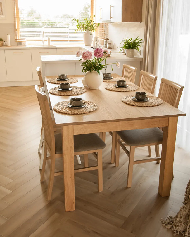 Dining table set with chairs in a bright kitchen