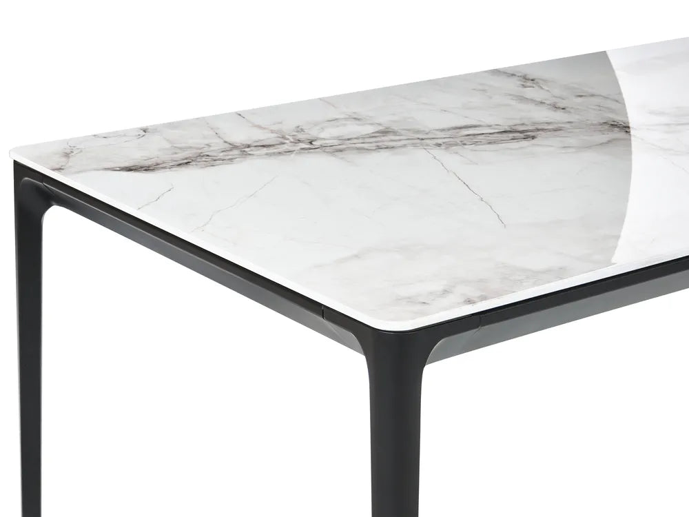 Table with marble-like top and black legs on a white background