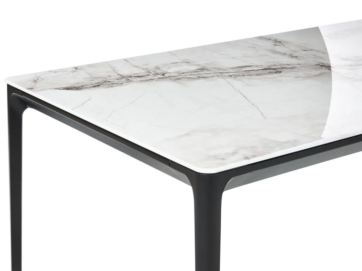Table with marble-like top and black legs on a white background