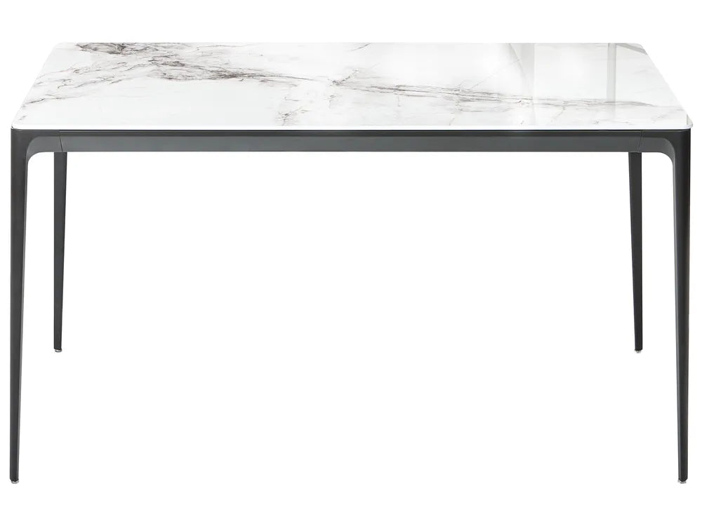 Dining table with marble-like top and black legs on a white background