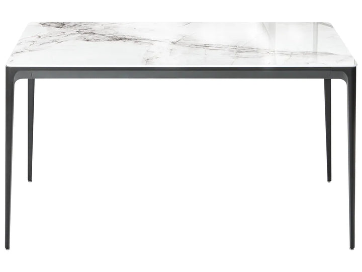 Dining table with marble-like top and black legs on a white background