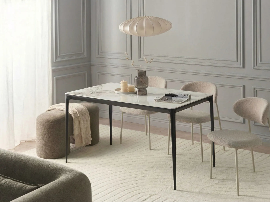 Modern dining room with a marble table and chairs in a stylishly decorated room.