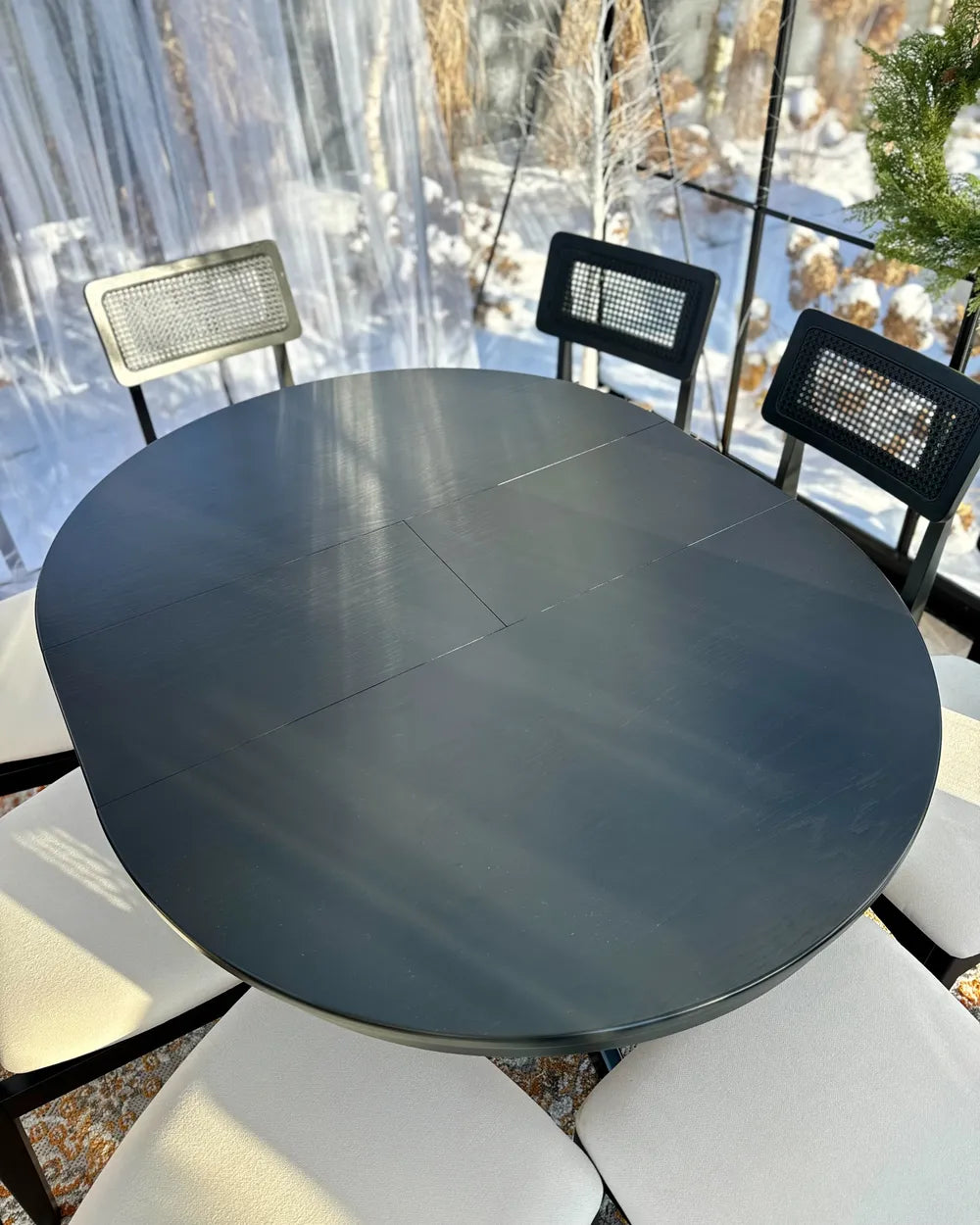 Round dark gray table with chairs in an outdoor setting