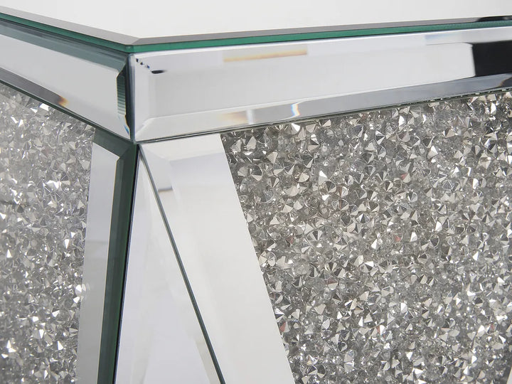 Close-up of a decorative table with crystal embellishments and a glass top.