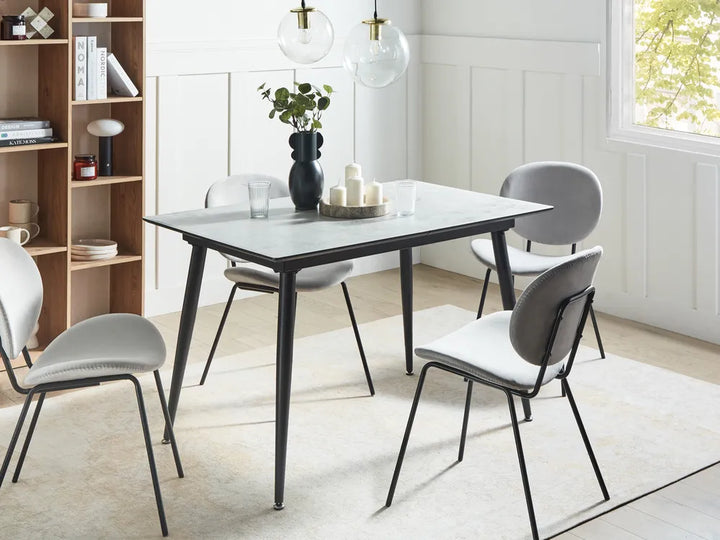 Dining room with a table and chairs in a modern interior setting.